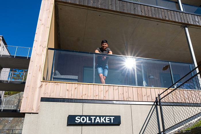 ung mann pa moderne balkong i solen